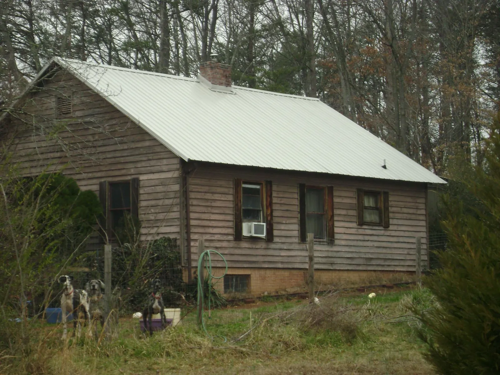 White metal roof on an old wood sided farmhouse, from a Metal Roof Installation job in Cape May Point